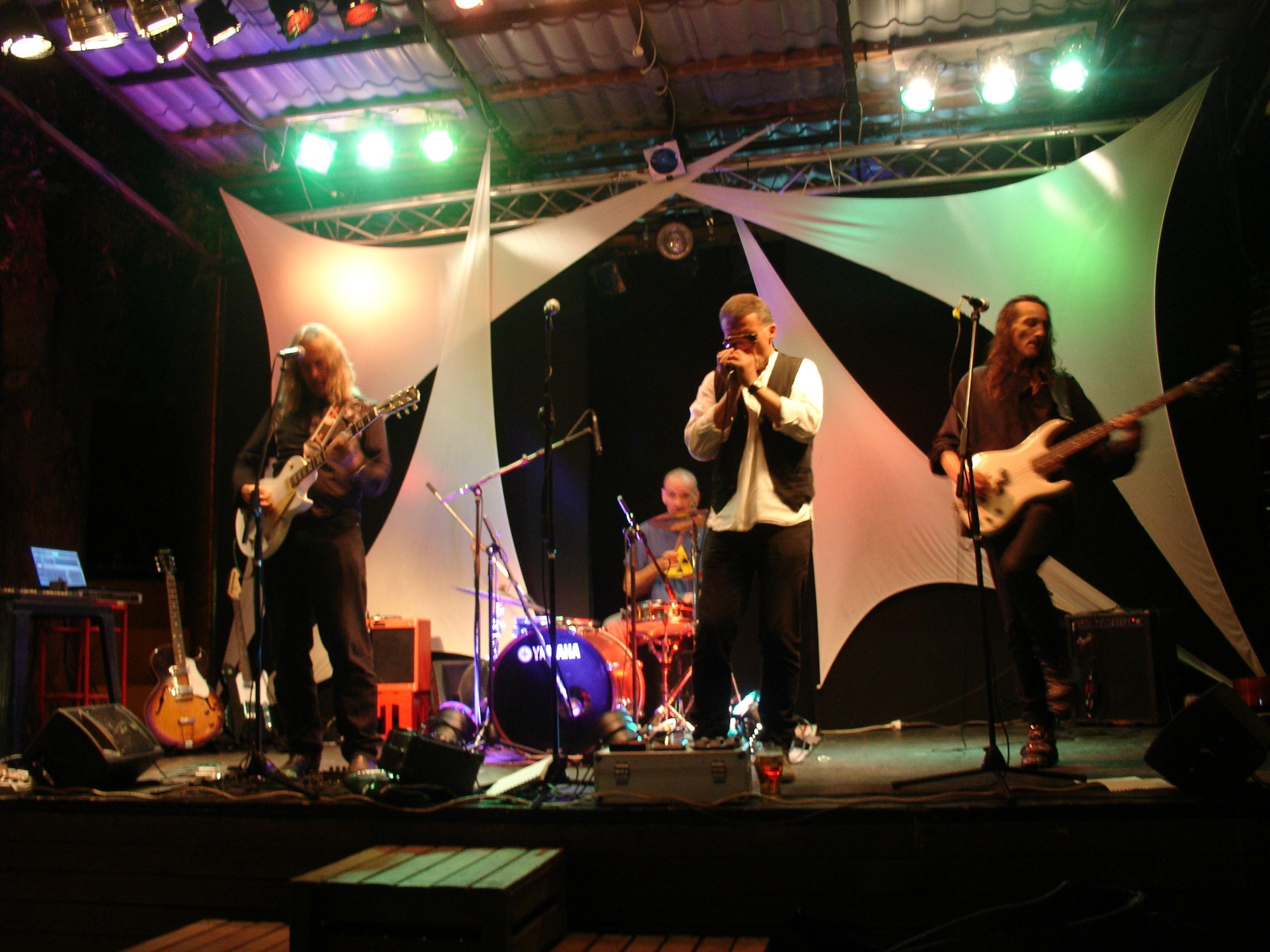 On stage under white sails and coloured lights