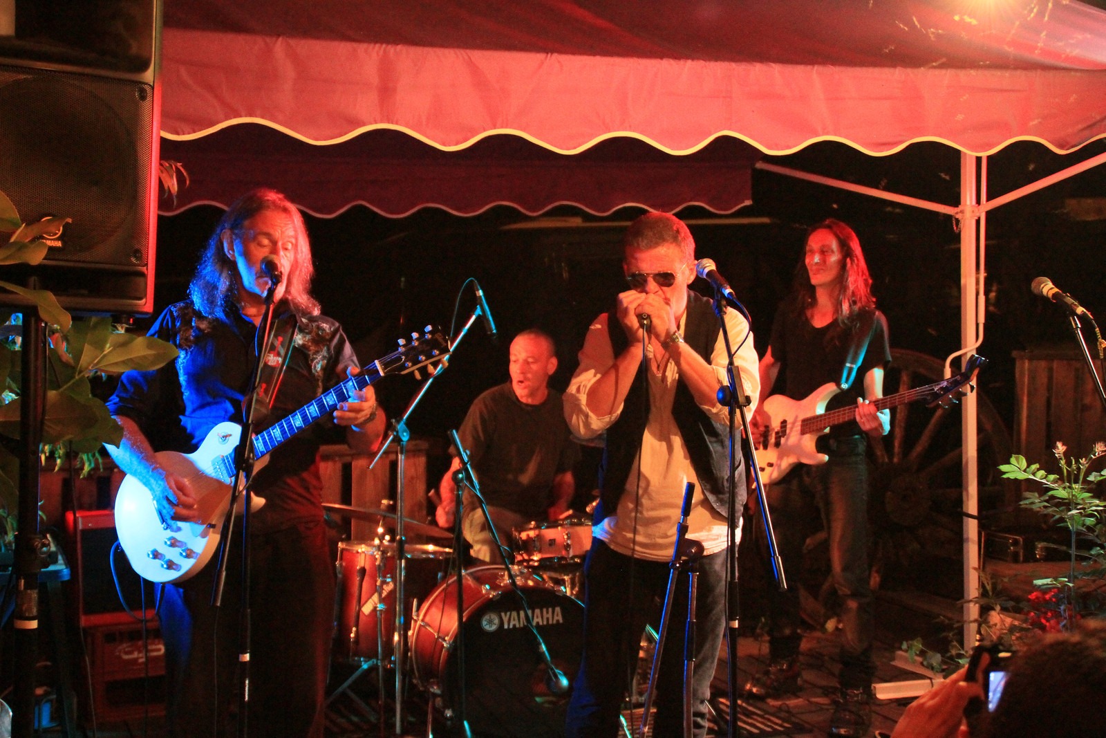 The band playing at night under the tent